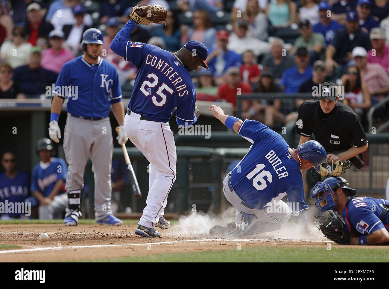 The Kansas City Royals Billy Butler 16 Slides Safely Into Home On A Wild Pitch By Texas Rangers Pitcher Jose Contreras 25 As Catcher J P Arencibia Right Dives In To Try To The Kansas City Royals Billy Butler 16 Slides Safely Into Home On A Wild Pitch By Texas Rangers Pitcher Jose Contreras 25 As Catcher J P Arencibia Right Dives In To Try To