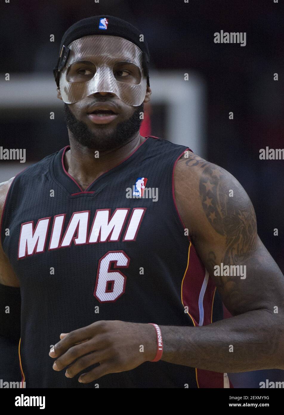 LeBron James (6) of the Miami Heat wears a protective face mask as his team  faces the Houston Rockets in the first half of their game on Tuesday, March  4, 2014, in