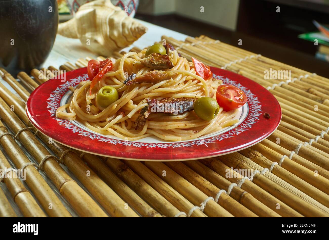 Salsa spaghetti with sardines Add the chilli flakes, tomatoes Stock Photo Alamy