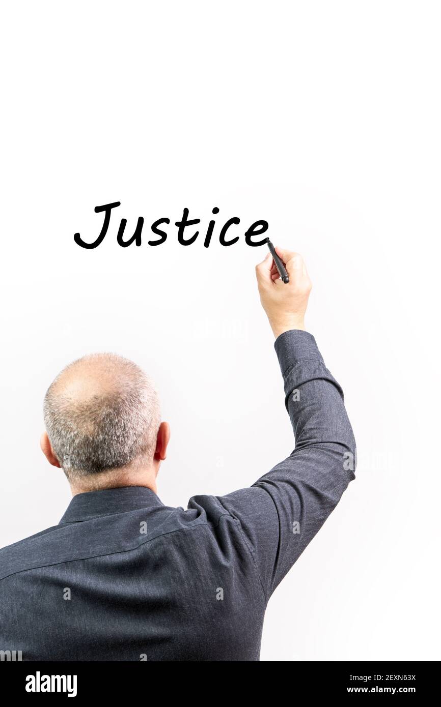 Man writing the word Justice on a white background. Concept Law and justice Stock Photo