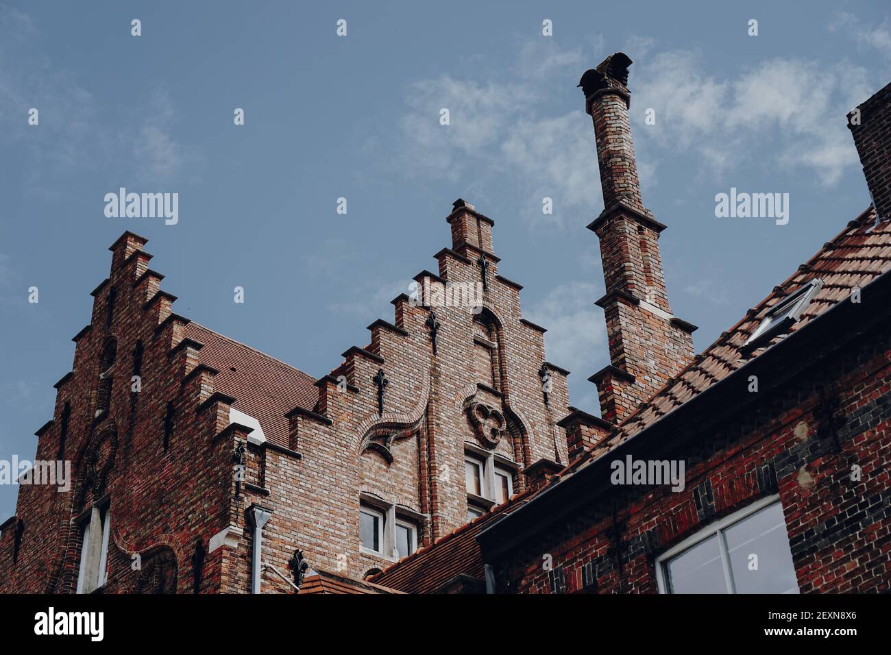 A low angle shot of stone buildings under a blue cloudy sky Stock Photo ...