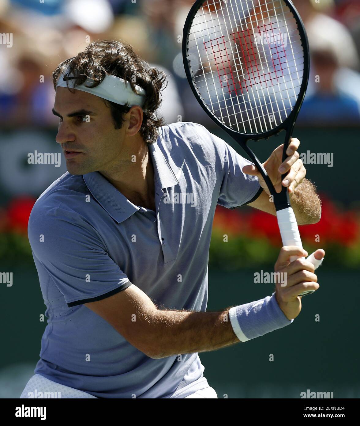 15 March, 2014: Roger Federer of Switzerland hits a return to Alexandr  Dolgopolov of the Ukraine during the BNP Paribas Open at Indian Wells  Tennis Garden in Indian Wells CA. (Photo by