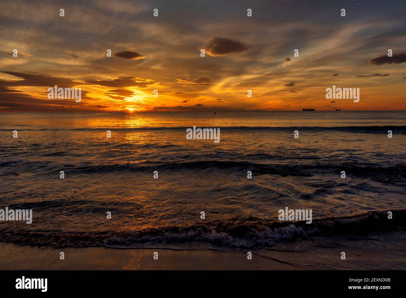 A nice and calm sunrise from the shore of the beach Stock Photo