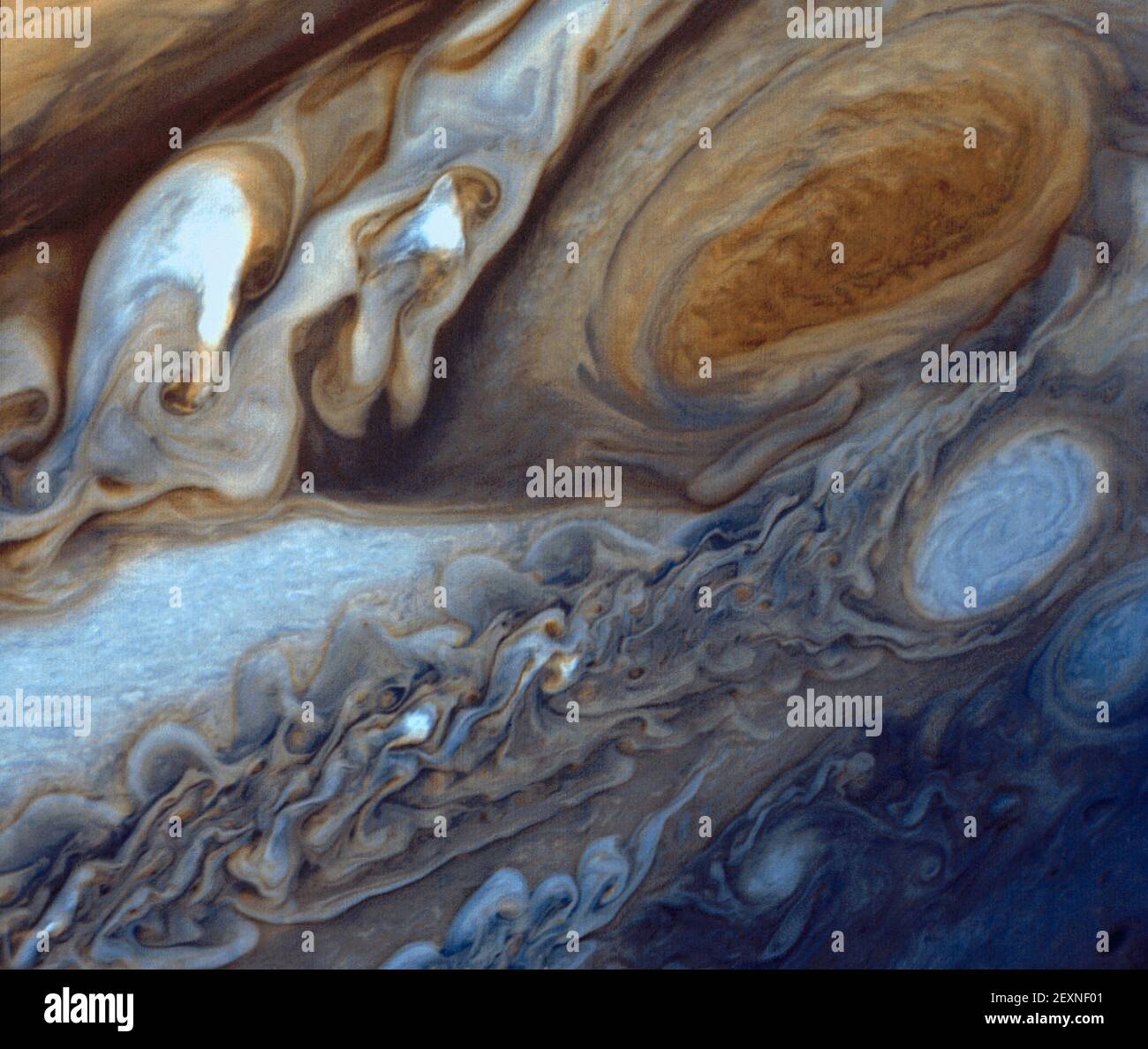 At about 89,000 miles in diameter, Jupiter could swallow 1,000 Earths. It is the largest planet in the solar system and perhaps the most majestic. Vibrant bands of clouds carried by winds that can exceed 400 mph continuously circle the planet's atmosphere. Such winds sustain spinning anticyclones like the Great Red Spot -- a raging storm three and a half times the size of Earth located in Jupiterâ€™s southern hemisphere. In January and February 1979, NASA's Voyager 1 spacecraft zoomed toward Jupiter, capturing hundreds of images during its approach, including this close-up of swirling clouds a Stock Photo