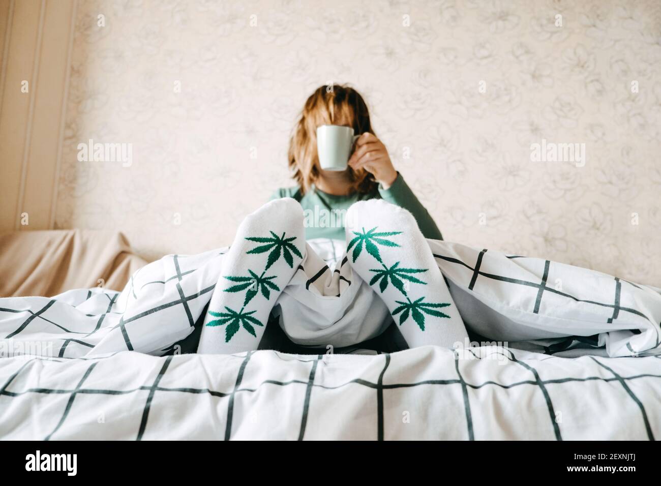 Self care, calm, mourning routine, start day. Mental health, self care, No stress, healthy habit, Use of Marijuana for Anxiety concept. Woman in socks Stock Photo