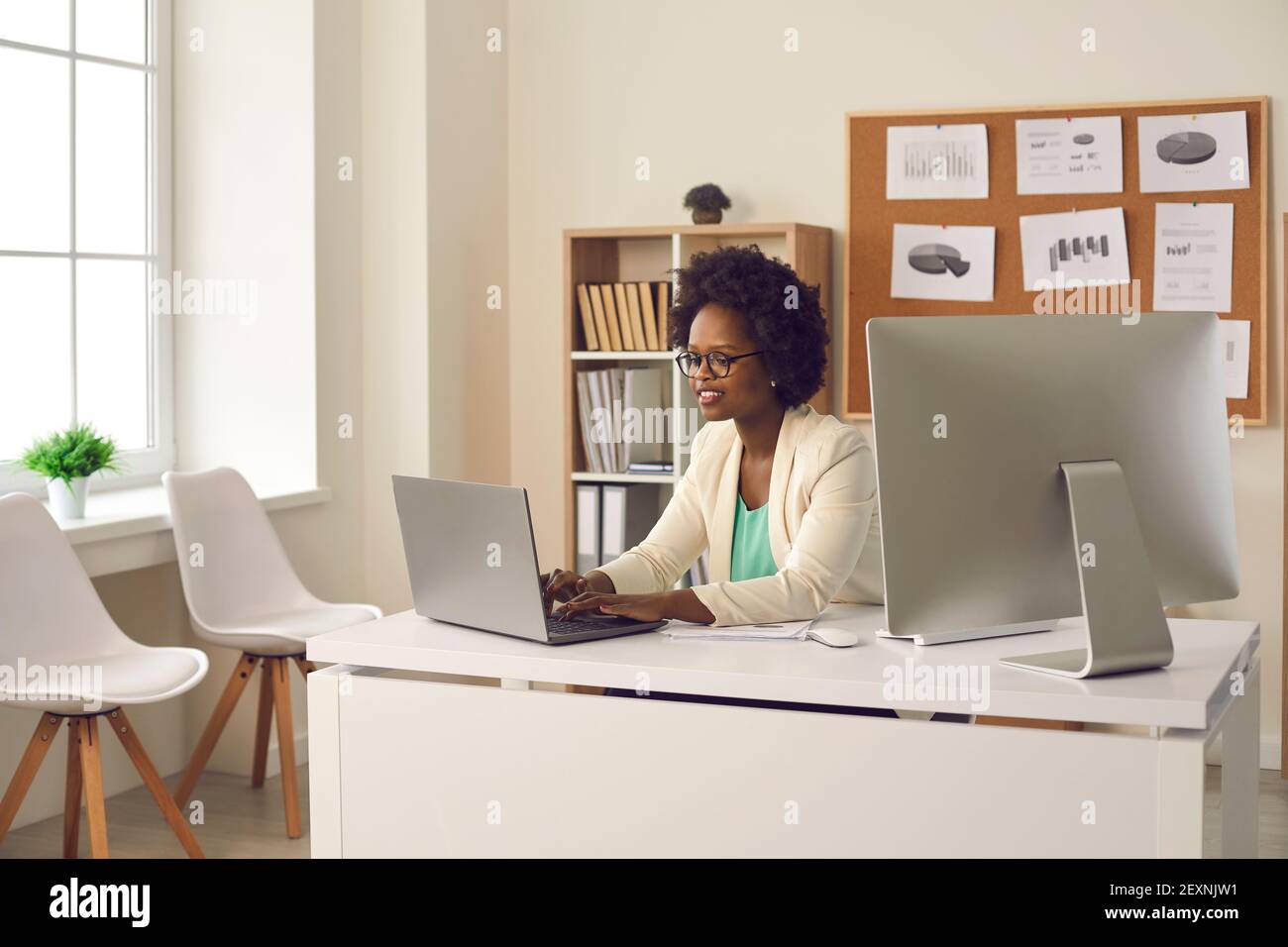 Experienced african american businesswoman typing on laptop in office Stock Photo