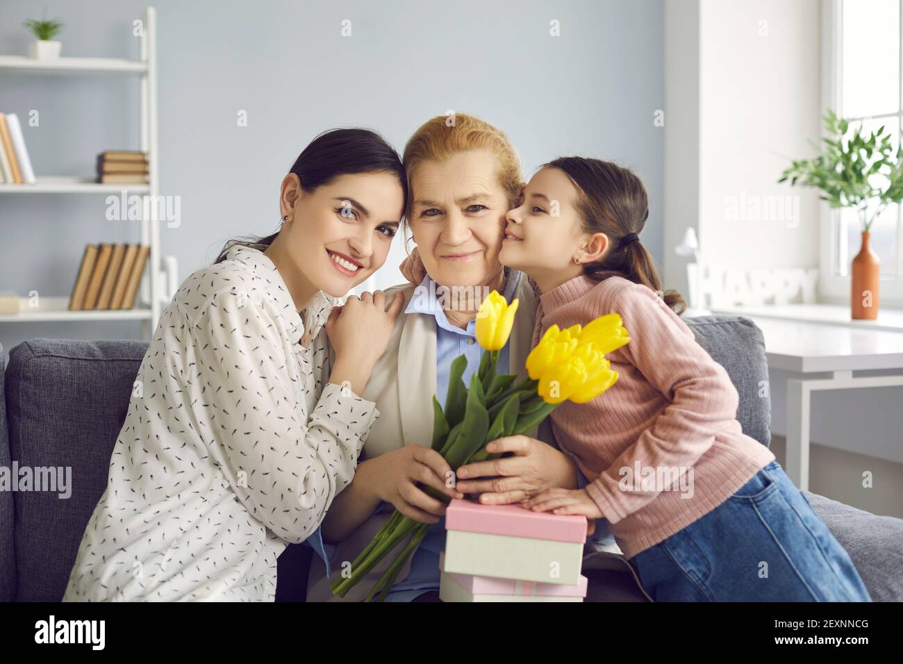 Portrait of three generations of women, mother, grandmother and granddaughter celebrating the event. Stock Photo