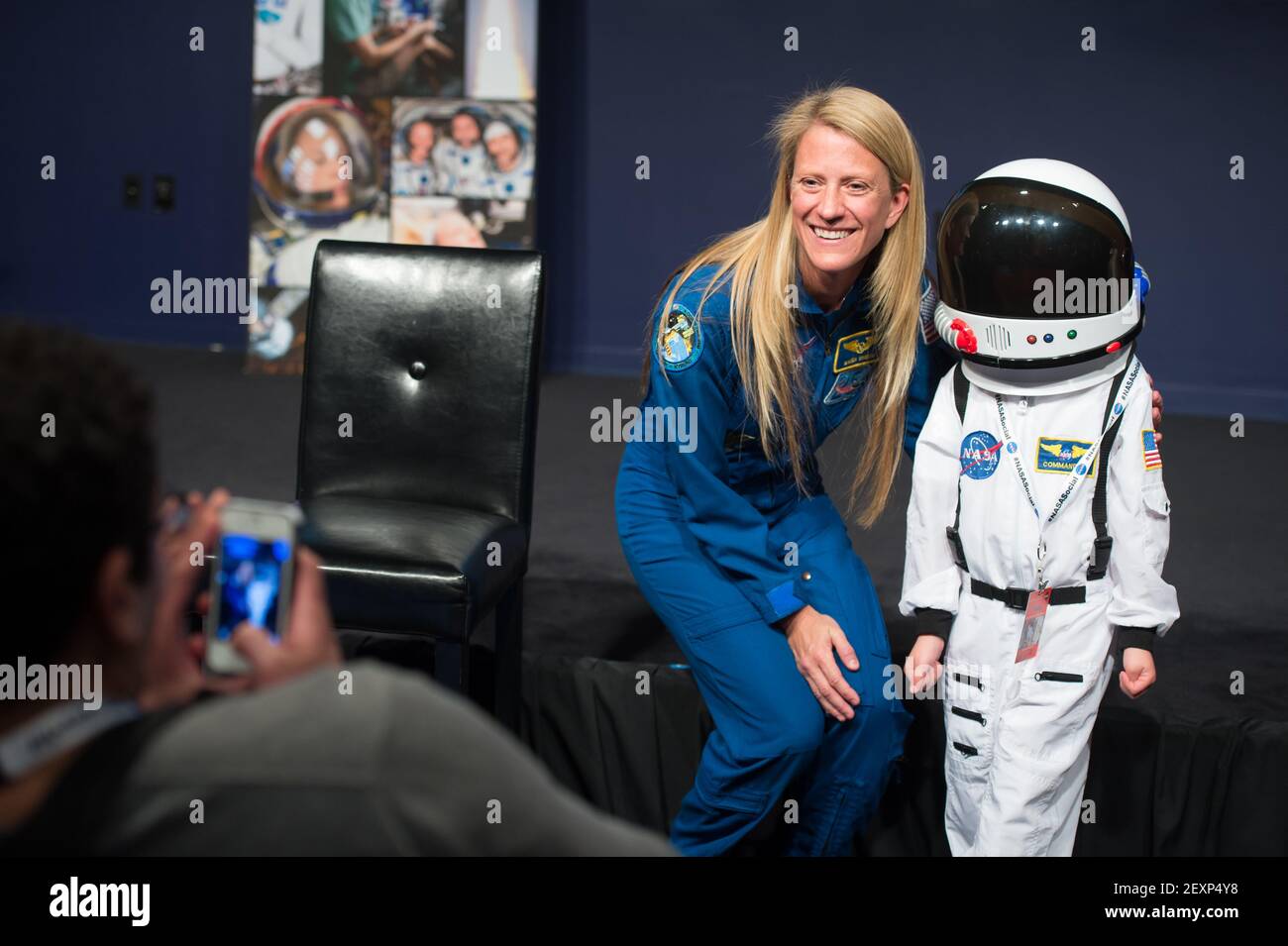 Astronaut Karen Nyberg poses for a photograph with an enthusiastic NASA Social attendee following a presentation about her time living, working, and conducting research on the International Space Station. The NASA Social was held on Monday, March 24, 2014 at NASA Headquarters in Washington, D.C. Nyberg served as a flight engineer aboard the space station during Expeditions 36 and 37, from May to November 2013. In addition to her time on the orbiting outpost, Nyberg also flew aboard space shuttle Discovery during its STS-124 mission in 2008. Image Credit: Aubrey Gemignani/NASA/Sipa USA Stock Photo