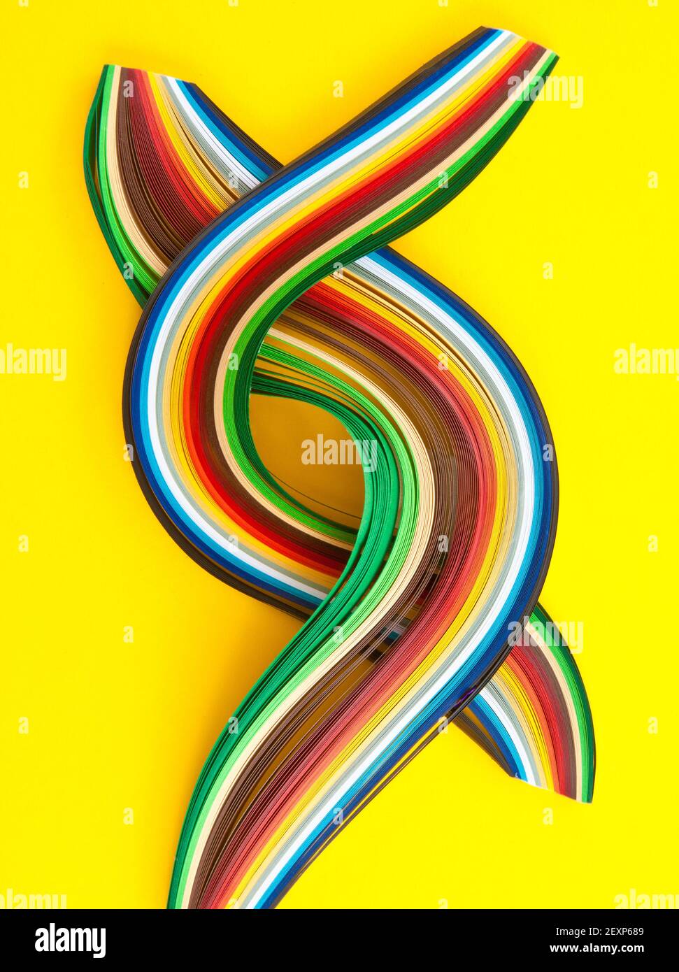 Colorful paper strips on yellow Stock Photo