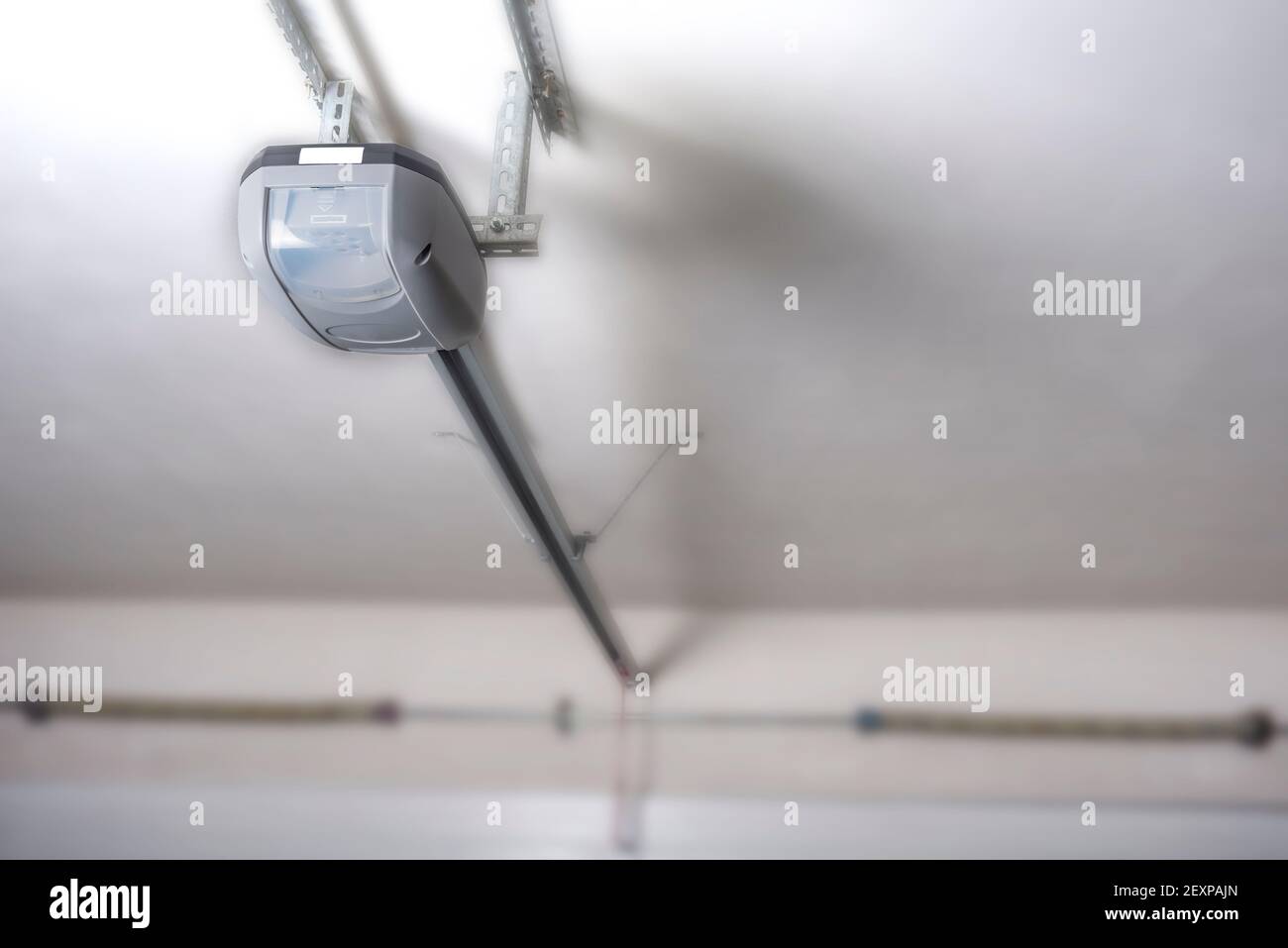 Electric garage door opener installed in garage Stock Photo Alamy