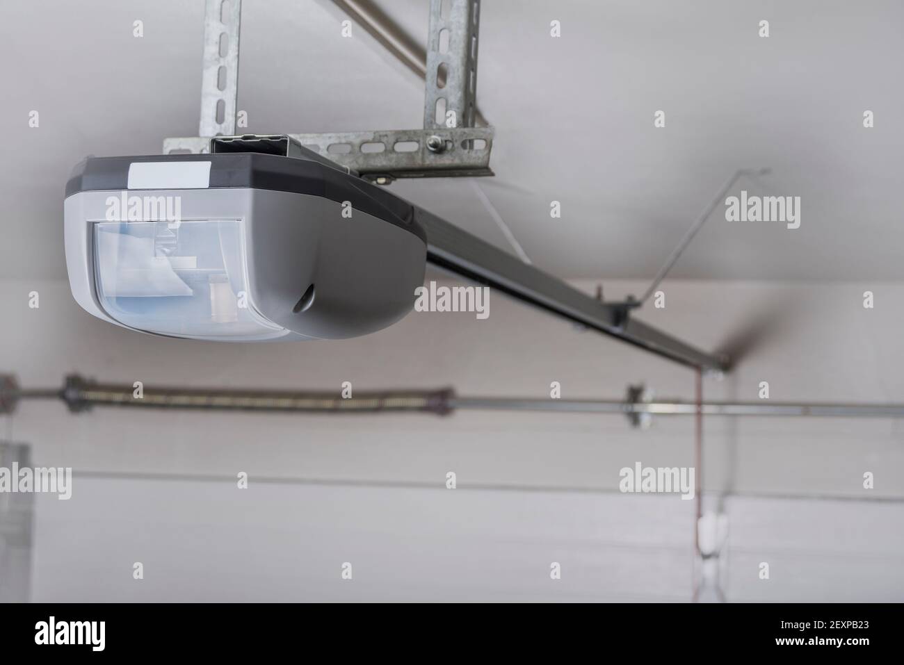 Electric garage door opener installed in garage Stock Photo Alamy