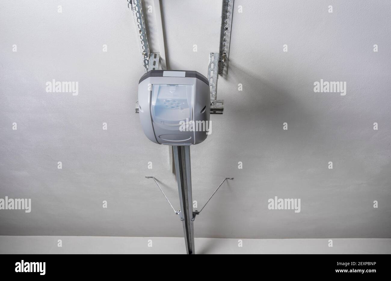 Electric garage door opener installed in garage Stock Photo Alamy