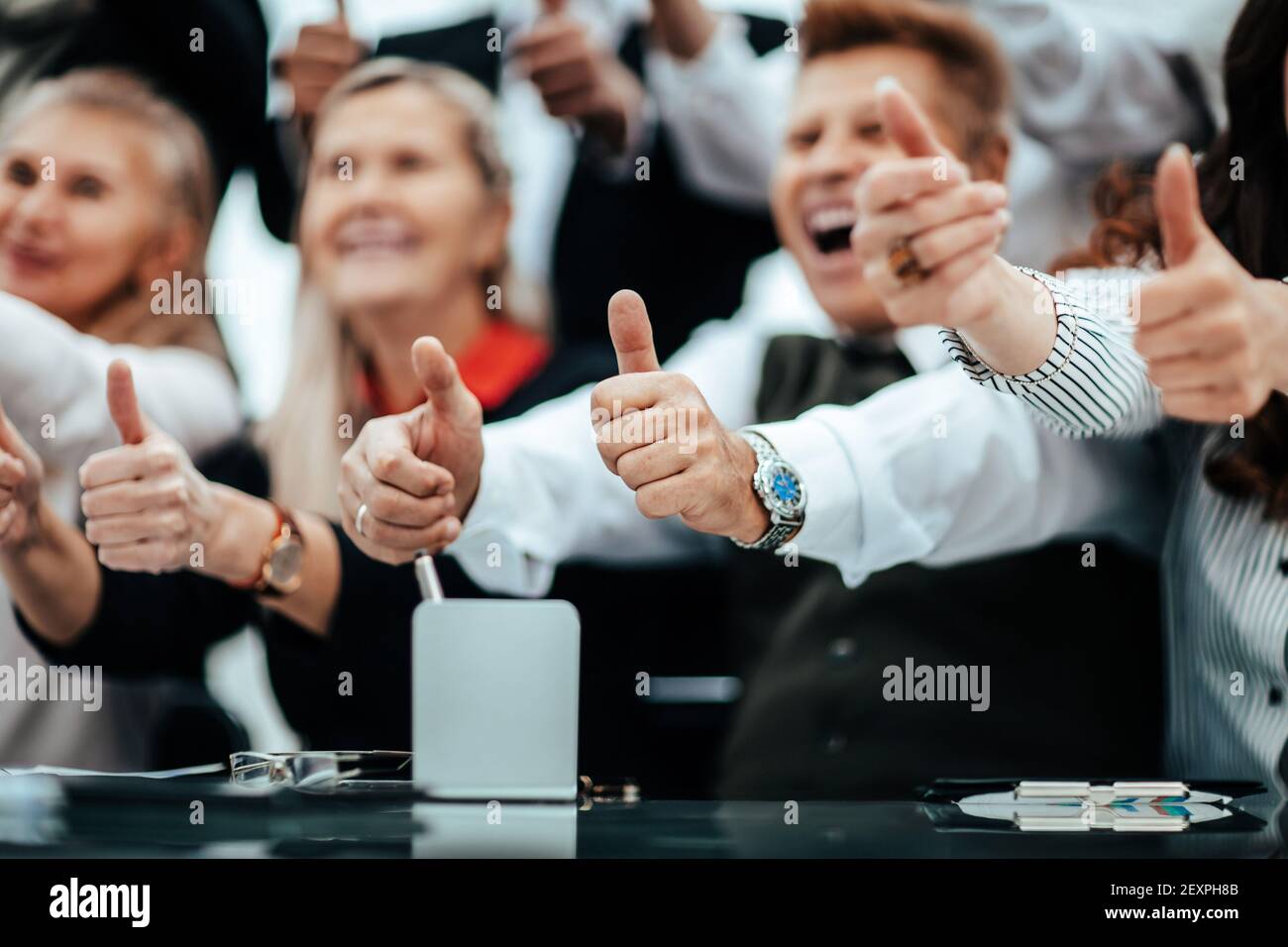 close up. image of business people showing thumbs up Stock Photo - Alamy