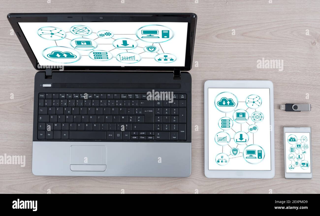 Cloud networking concept shown on different information technology devices Stock Photo