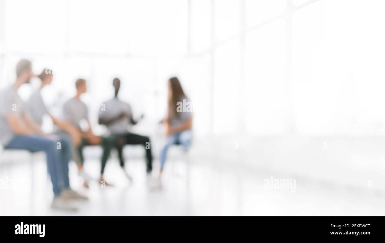 background image of a group of young people at a meeting in a ...