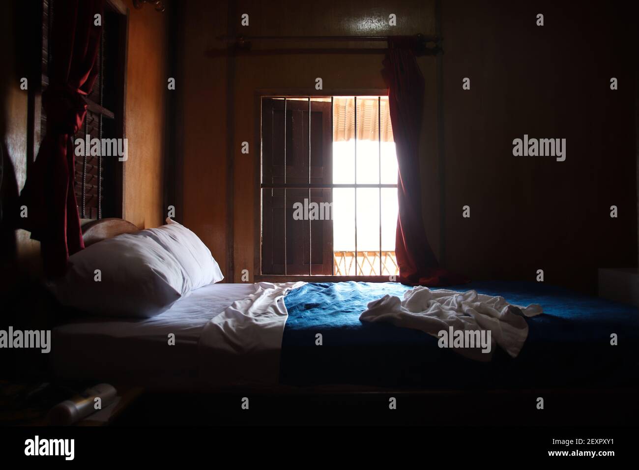 A messy bed with light coming from the window Stock Photo - Alamy