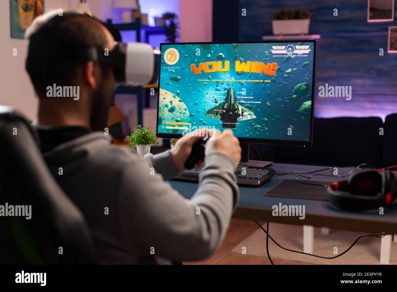 Gamer man winning space shooter game use virtual reality goggles