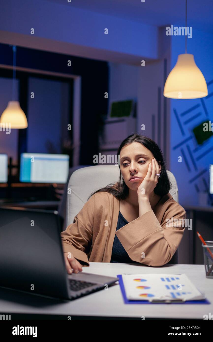 Overworked Manager Overworked manager working on financial deadline sitting at desk. Smart ...