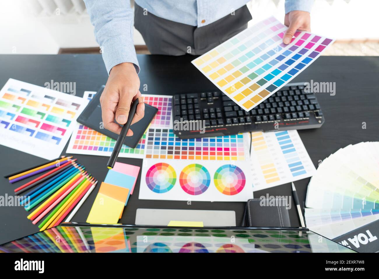creative graphic designer choosing color scale for editing artwork