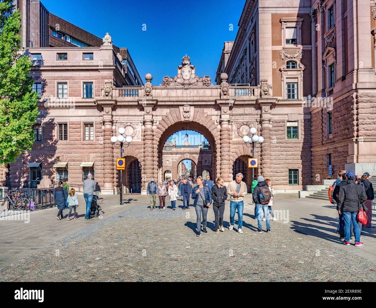 18 September 2018: Stockholm, Sweden - Shoppers coming through the arches of the Parliament building, the Sveriges Rikstag. Stock Photo