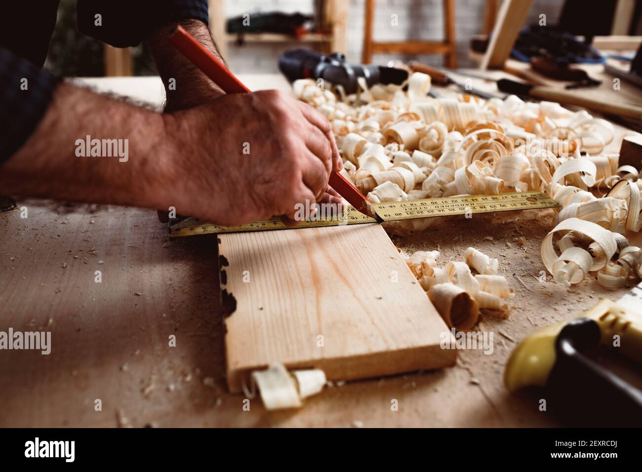 Carpenter makes pencil marks on a wood plank Stock Photo Alamy