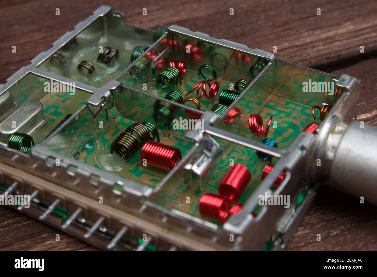 Electromagnetic air-core inductors for high frequencies on circuit board panoramic background. Electronic coils inside detail of TV device for receivi Stock Photo