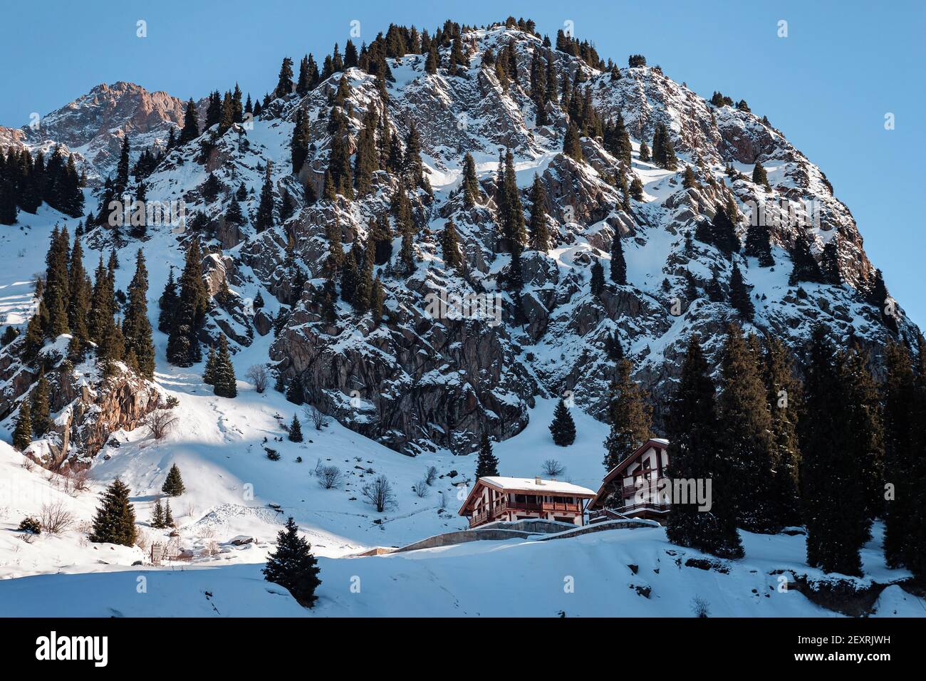 Almaty Region, Kazakhstan - FEBRUARY 28, 2021: Winter landscape with houses in the mountains. Morning in the mountains of the Zailiyskiy Alatau. The a Stock Photo