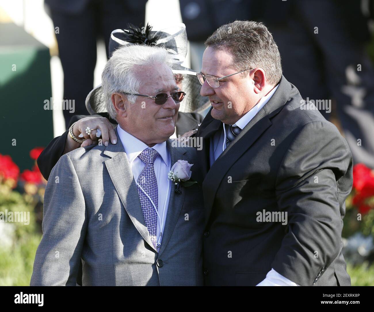 Winning trainer Art Sherman, left, is hugged by his son, assistant