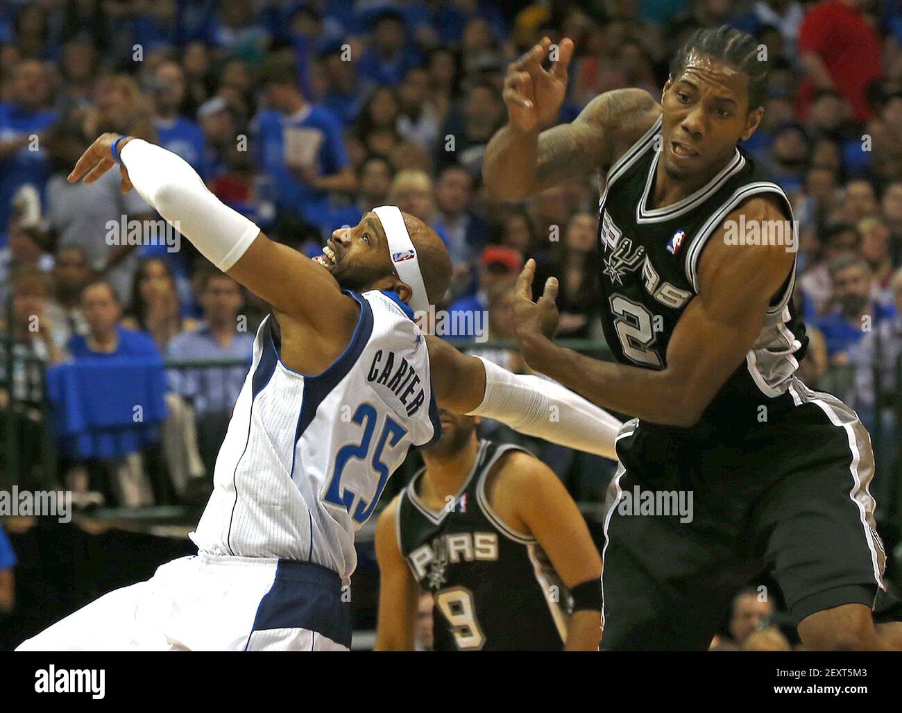 Dallas Mavericks guard Vince Carter (25) is fouled by San Antonio Spurs  forward Kawhi Leonard (2) during Game 6 of an NBA Western Conference  quarterfinal at the American Airlines in Dallas, Friday