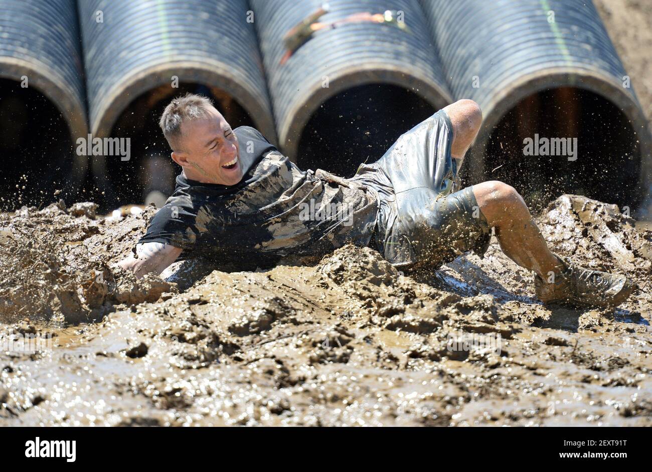 After crawling down a pipe into muddy water a Tough Mudder participant ...