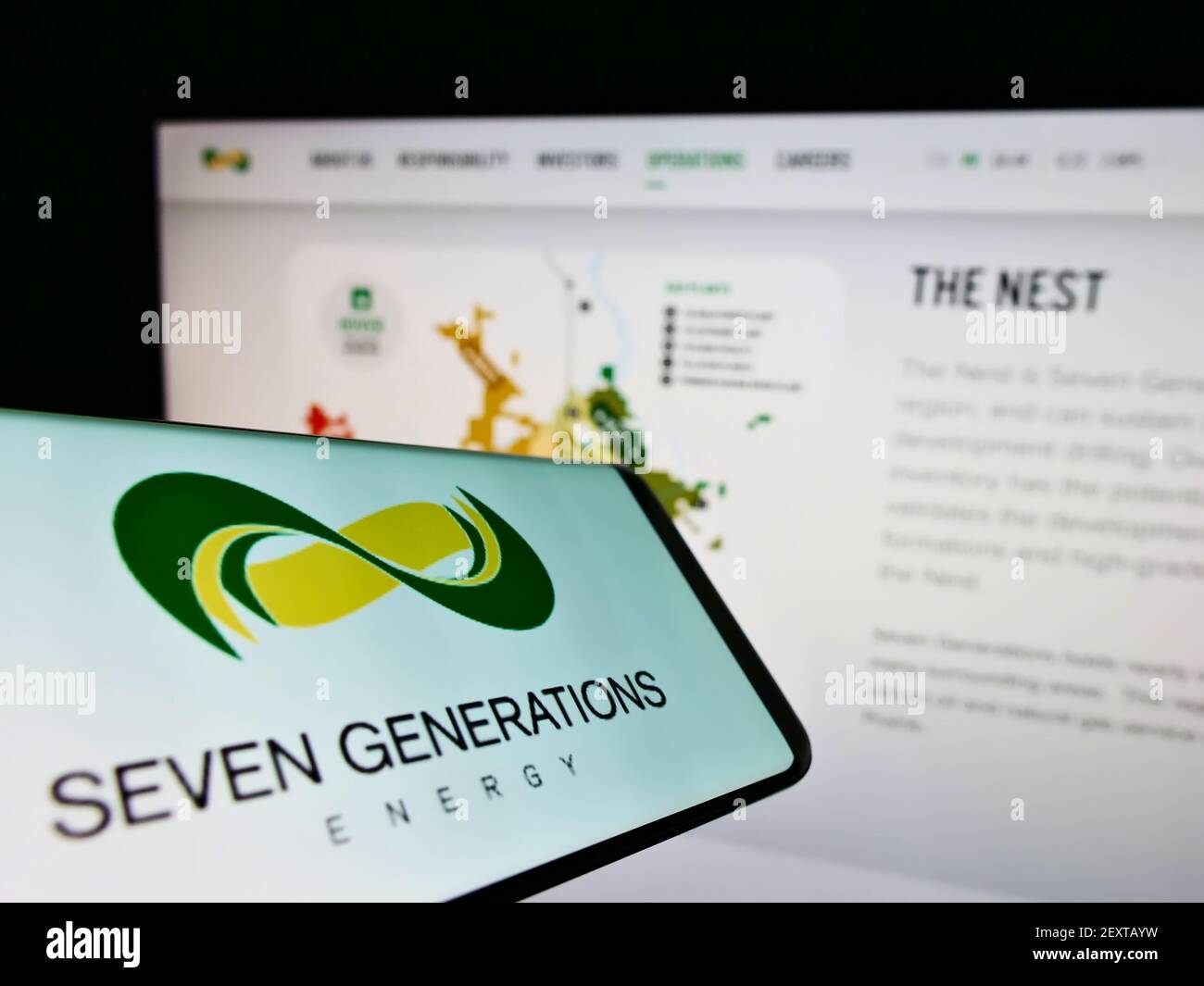 Cellphone with logo of oil and gas company Seven Generations Energy Ltd. on screen in front of website. Focus on center-right of phone display. Stock Photo