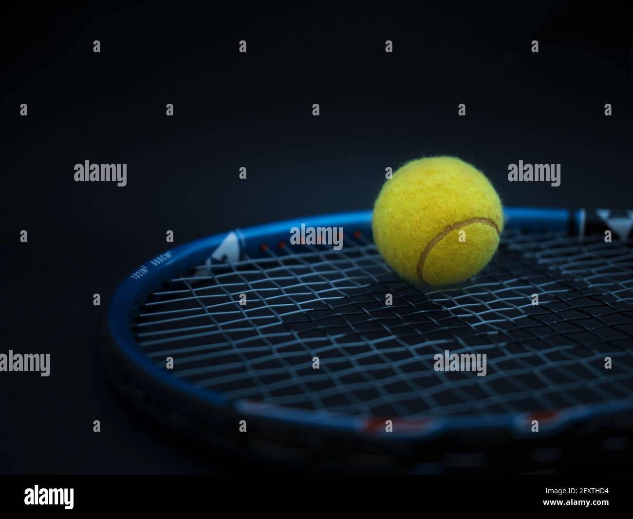 Sport and healthy lifestyle. Tennis. Yellow ball for tennis and a racket on table. Sports background with tennis concept, photo Stock Photo