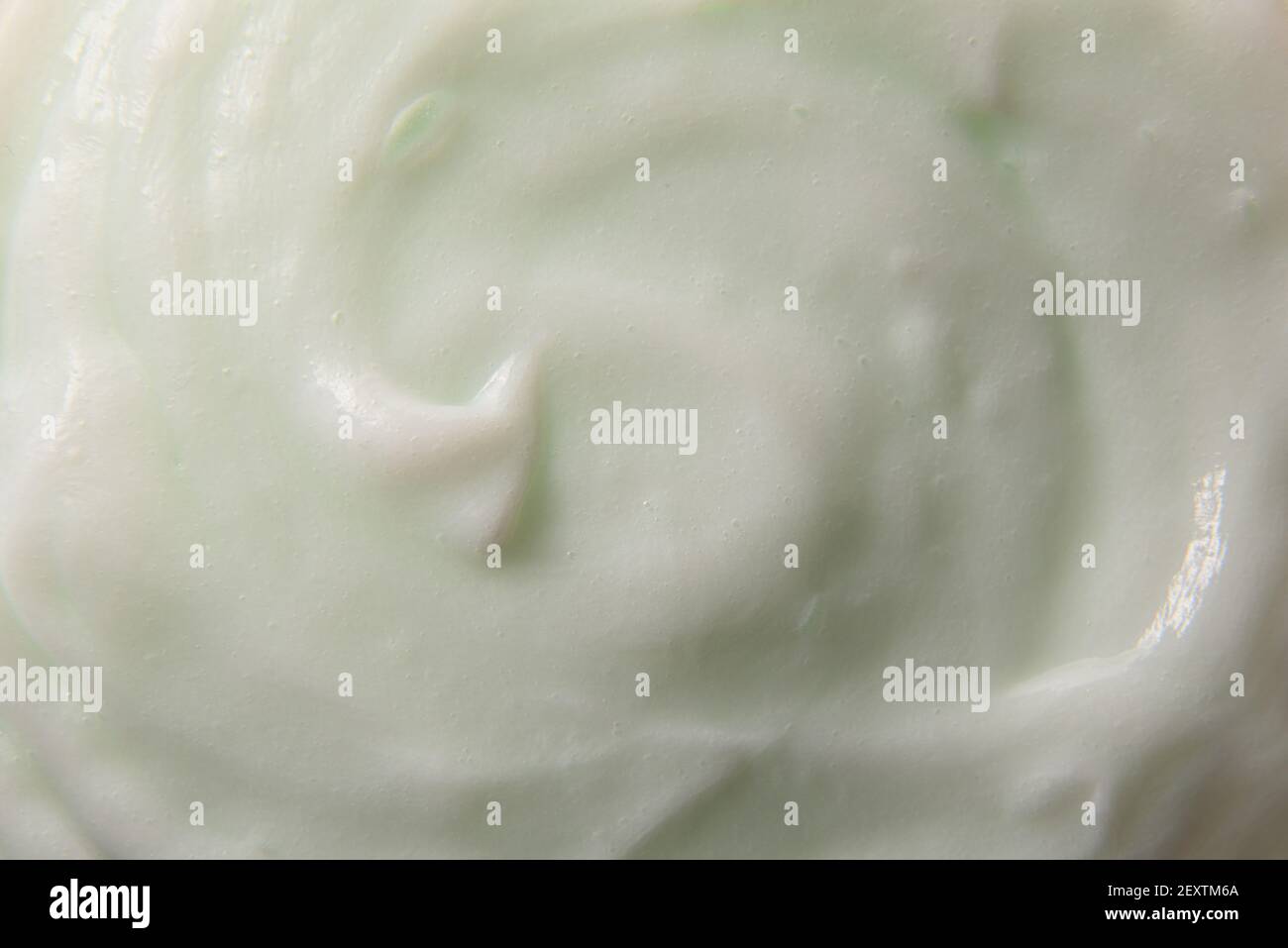 Greenish body cream texture abstract background. Horizontal composition. Stock Photo