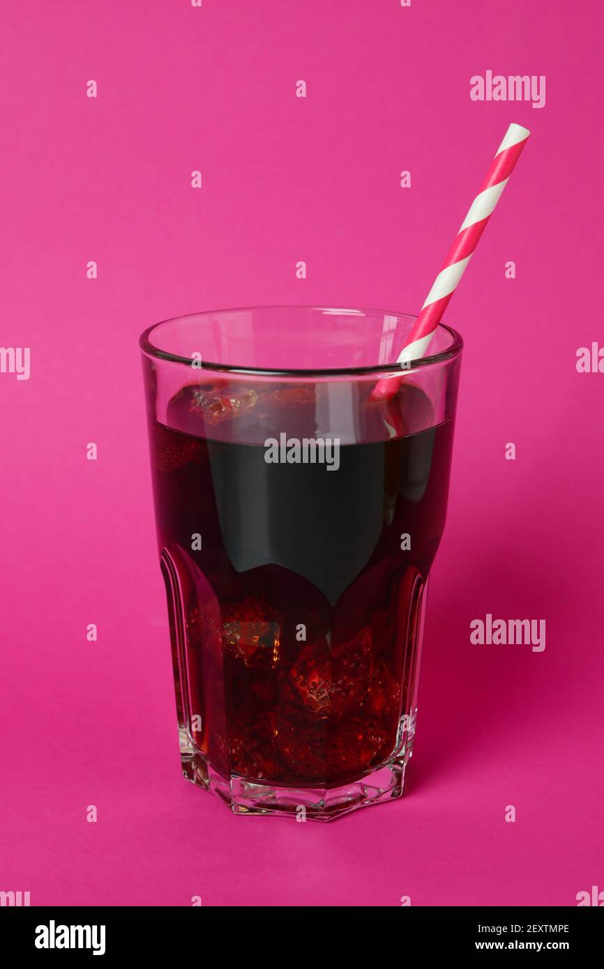 Glass of cola with ice cubes and straw on pink background Stock Photo ...