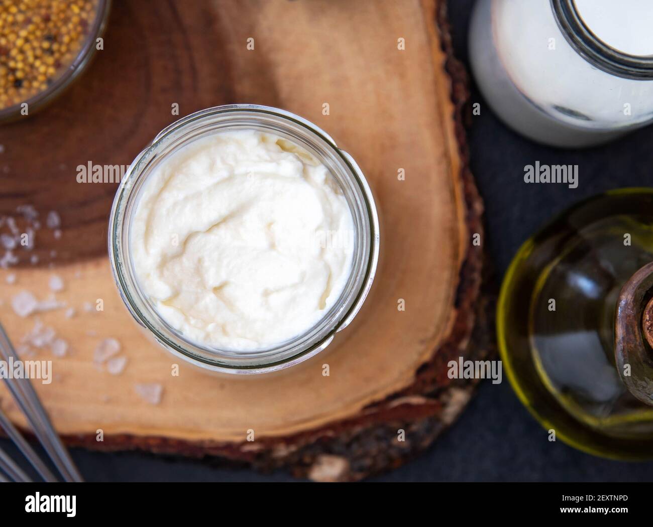 Vegetarian mayonnaise. Ingredients for mayonnaise oil, milk and mustard. Homemade mayonnaise