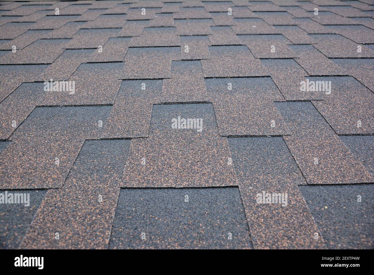 Copper brown roofing asphalt shingles texture background. A closeup of