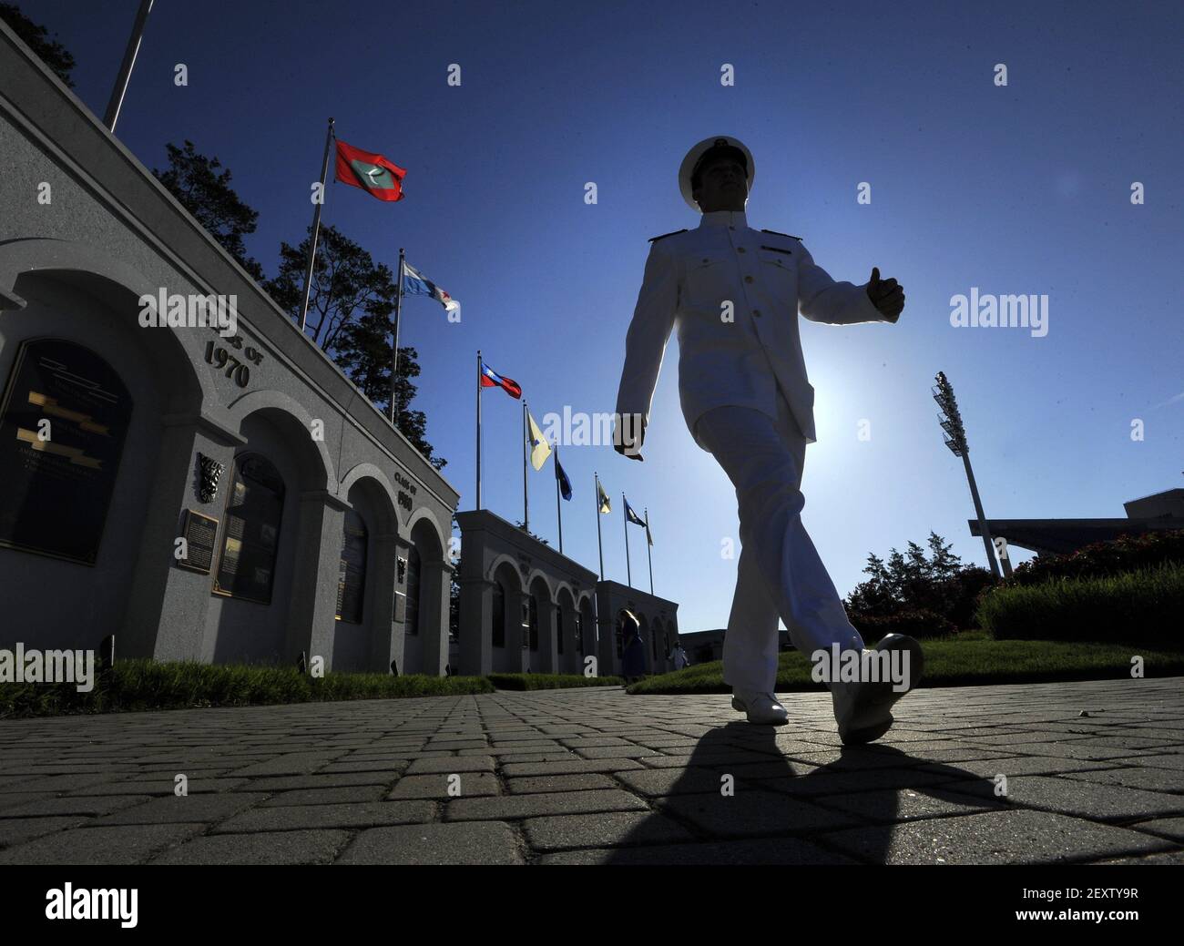 Midshipman Shawn Reed gets ready for graduation as he walks inside the ...