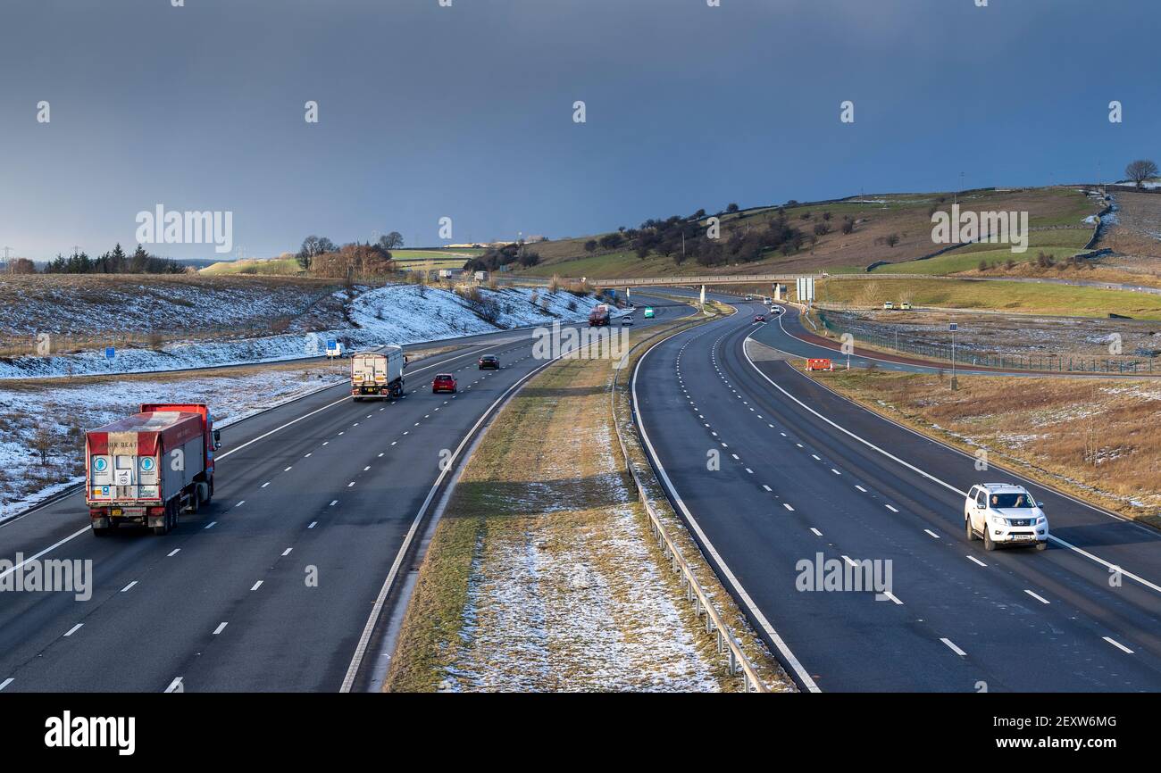 Traffic on the M6 Motorway at Shap in Cumbria on a winters evening. Stock Photo
