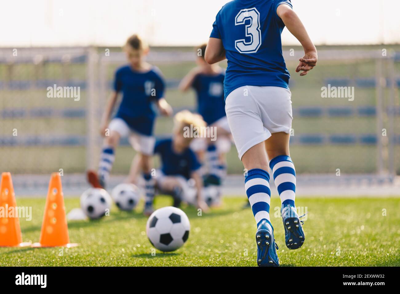 Boy Running on Grass Field in Soccer Cleats. Closeup image on Football