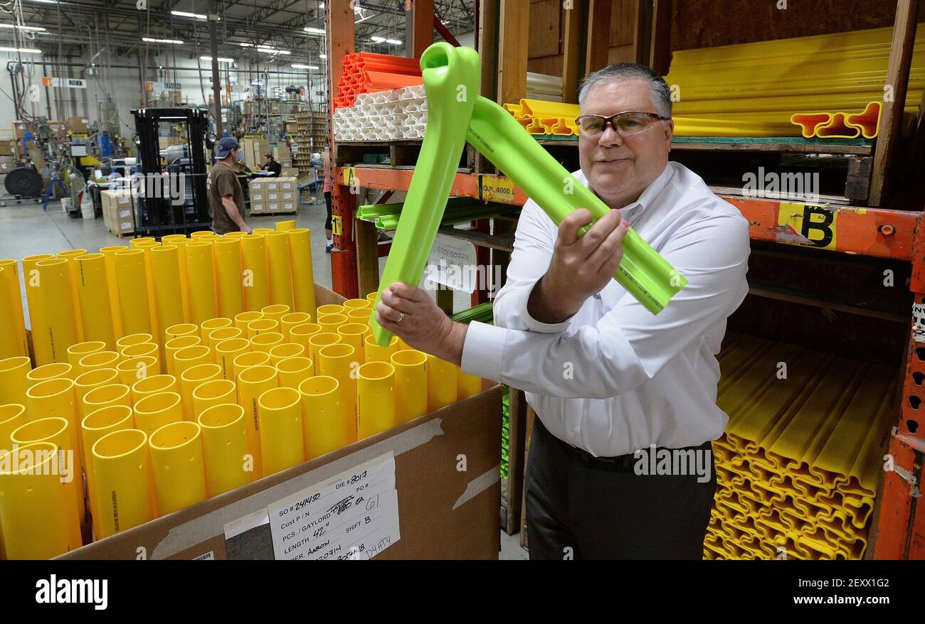 Peter Speer, vice president of sales at Pexco, demonstrates the flexibility  and durability of the company's traffic safety poles at the company's  manufacturing center in Fife on Wednesday, June 11, 2014. The