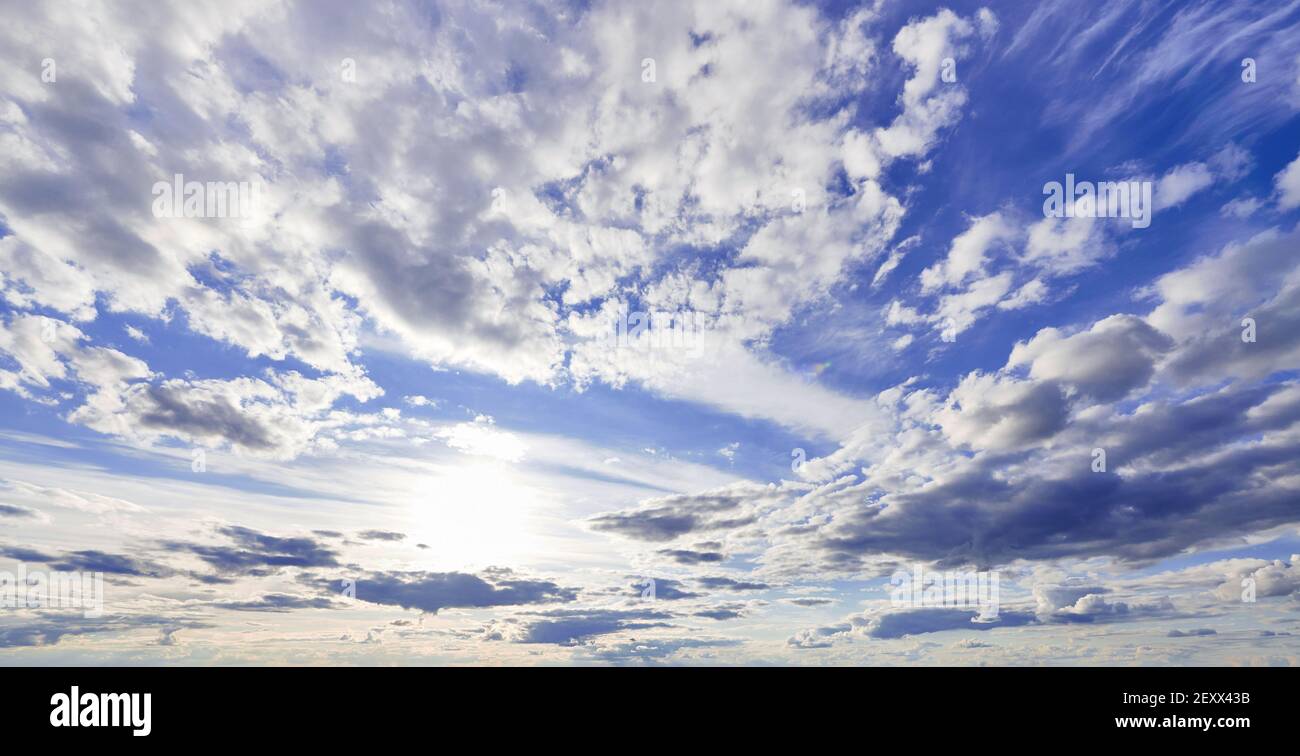 Blue sky with cumulus white clouds in sunshine Stock Photo - Alamy