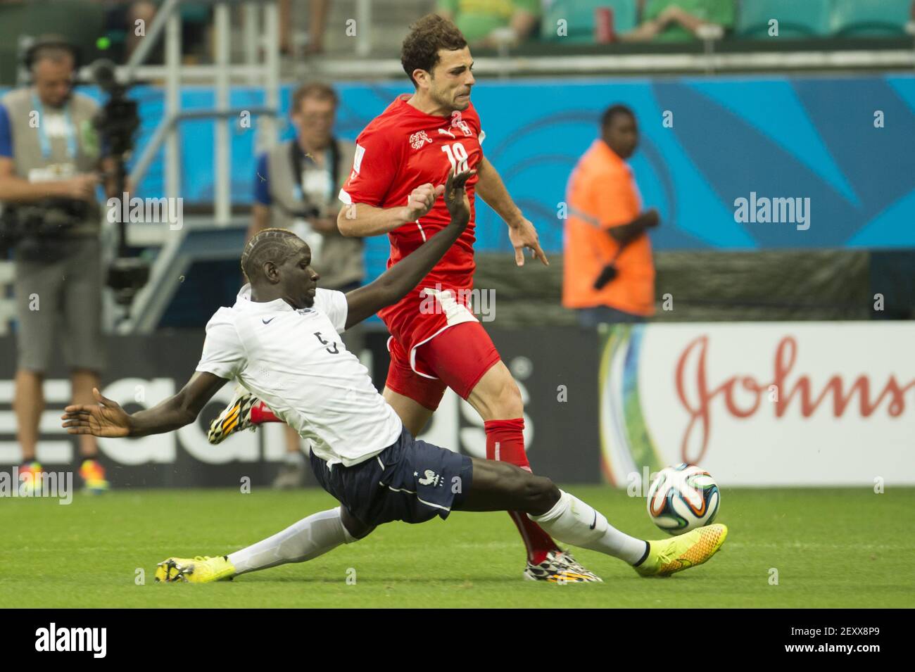 France's MAMADOU SKHO (L) fights for the ball with Switzerland's ADMIR  MEHMEDI (R) during the group E 2014 FIFA World Cup soccer match between  Switzerland and France, in Arena Fonte Nova Stadium