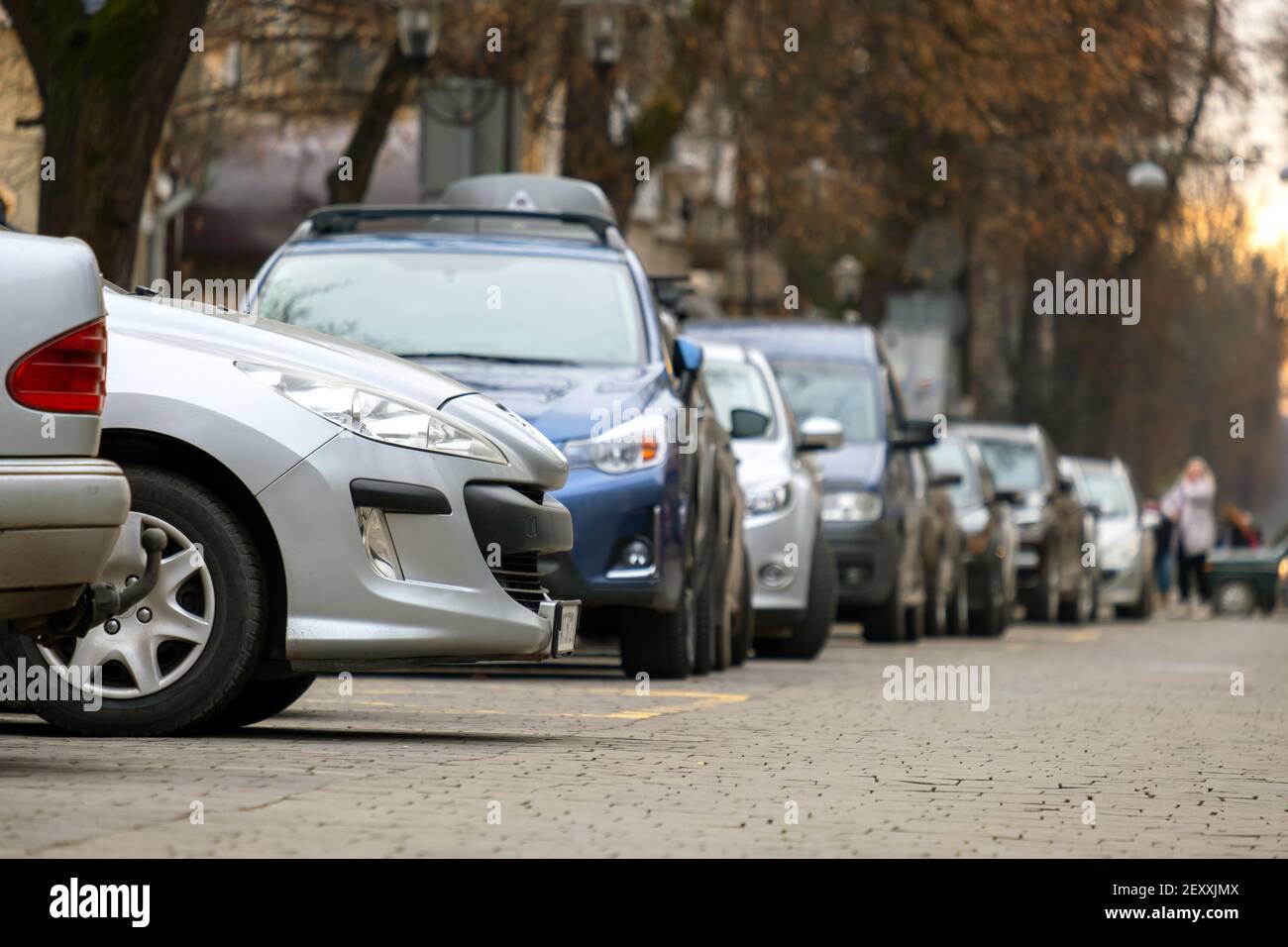 Cars parked in a row on a city street side Stock Photo - Alamy