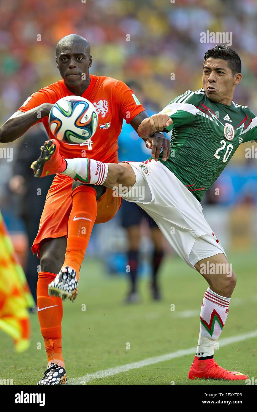 Netherlands' Bruno MARTINS INDI (L) vies with Mexico's Javier AQUINO (R) during the Round of 16 of the 2014 FIFA World Cup soccer match between Netherlands and Mexico, in Castelao Stadium in Fortaleza, Brazil, on June 29, 2014. Photo by Omar Martinez/ Mexsport/ Fotoarena/Sipa USA Stock Photo