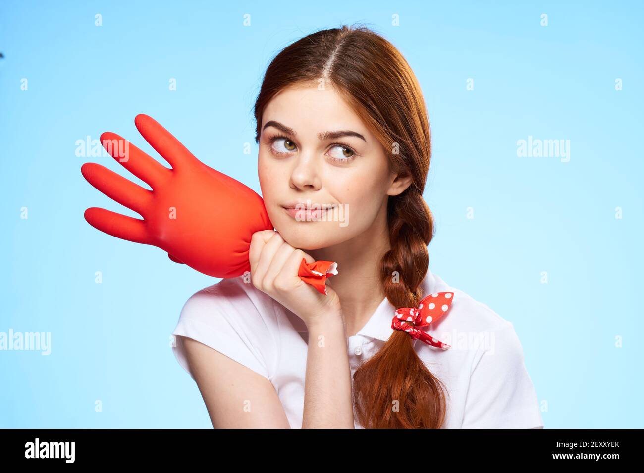 cleaning lady with inflated rubber glove in hand lifestyle fun Stock