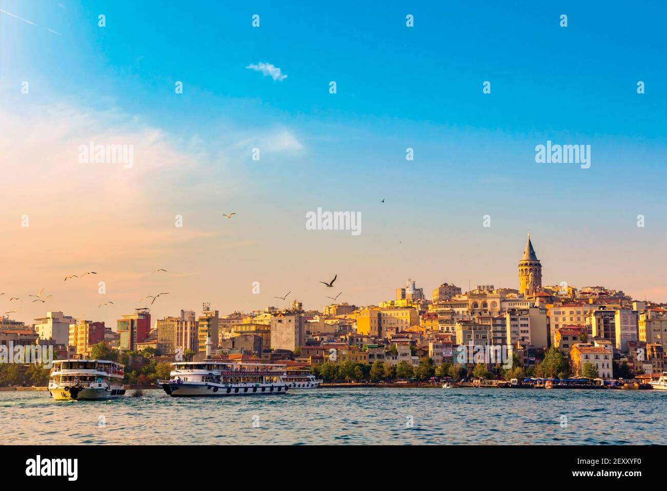 Istanbul, Istanbul Province, Turkey.  Ferry boats with Galata Tower in background seen over the Golden Horn. Stock Photo