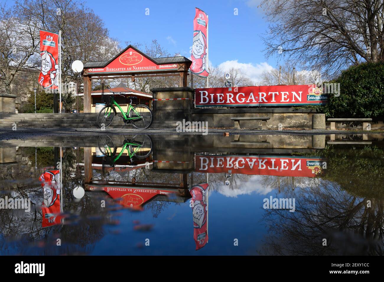 Dresden, Germany. 05th Mar, 2021. An empty beer garden is reflected in a puddle. Credit: Sebastian Kahnert/dpa-Zentralbild/dpa/Alamy Live News Stock Photo