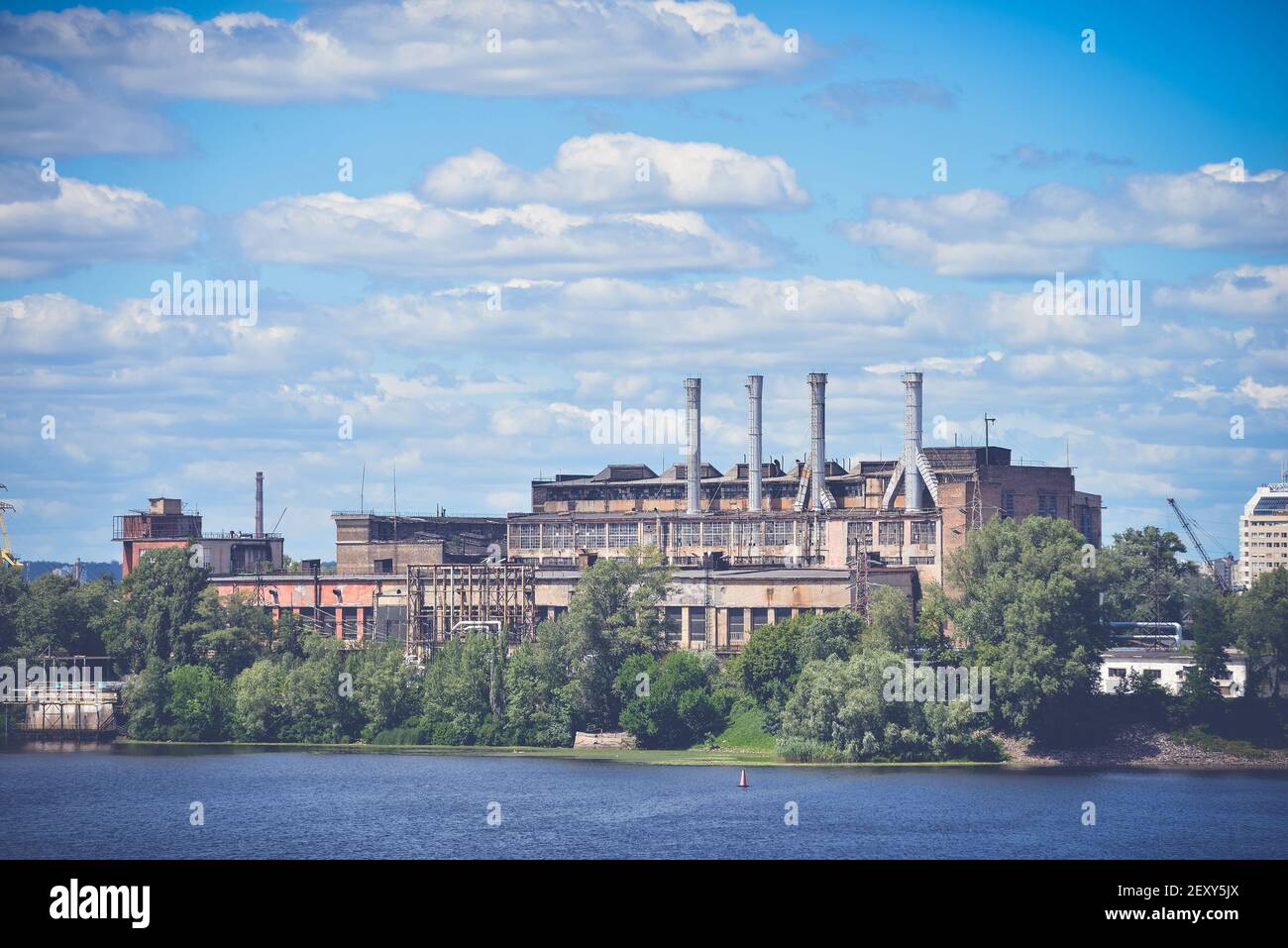 Old industrial building on the river bank Stock Photo