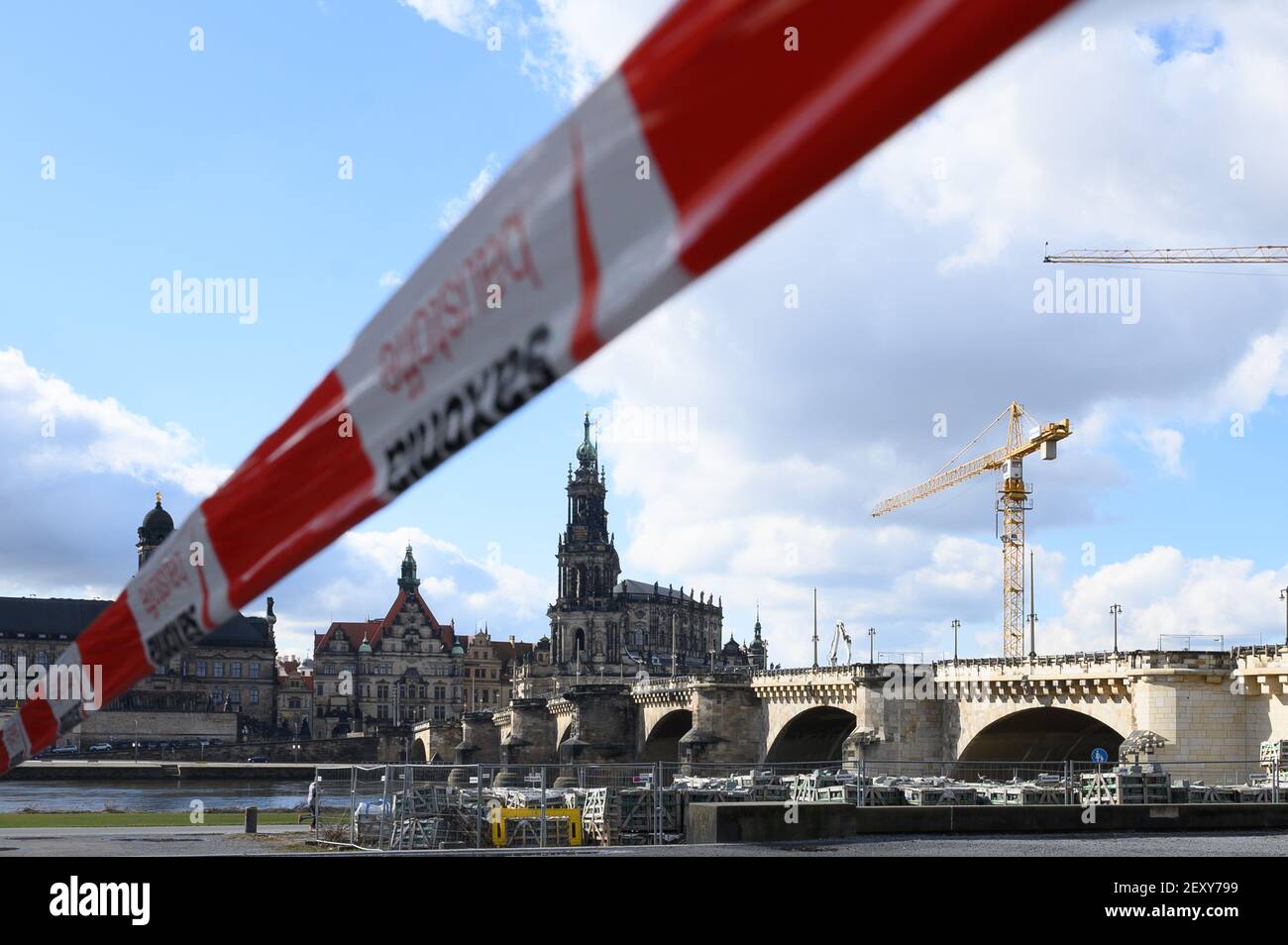 Dresden, Germany. 05th Mar, 2021. A barrier tape hangs in front of the Augustus Bridge and the Catholic Court Church. Credit: Sebastian Kahnert/dpa-Zentralbild/dpa/Alamy Live News Stock Photo