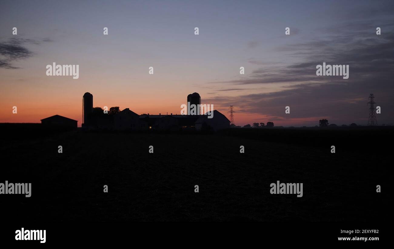 View of a Sunrise Looking over an Amish Farm with Farm House Barn and ...